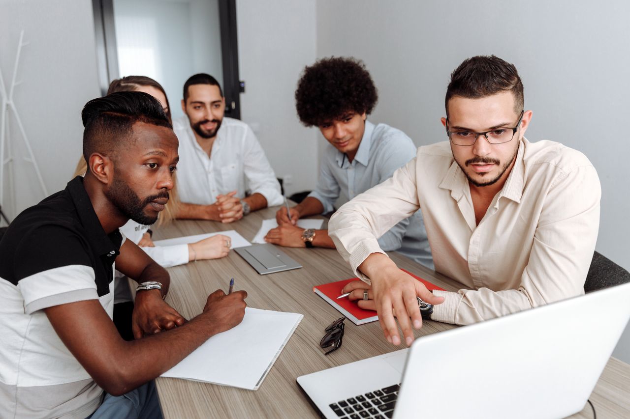 Developers reviewing application code and project deliverables together