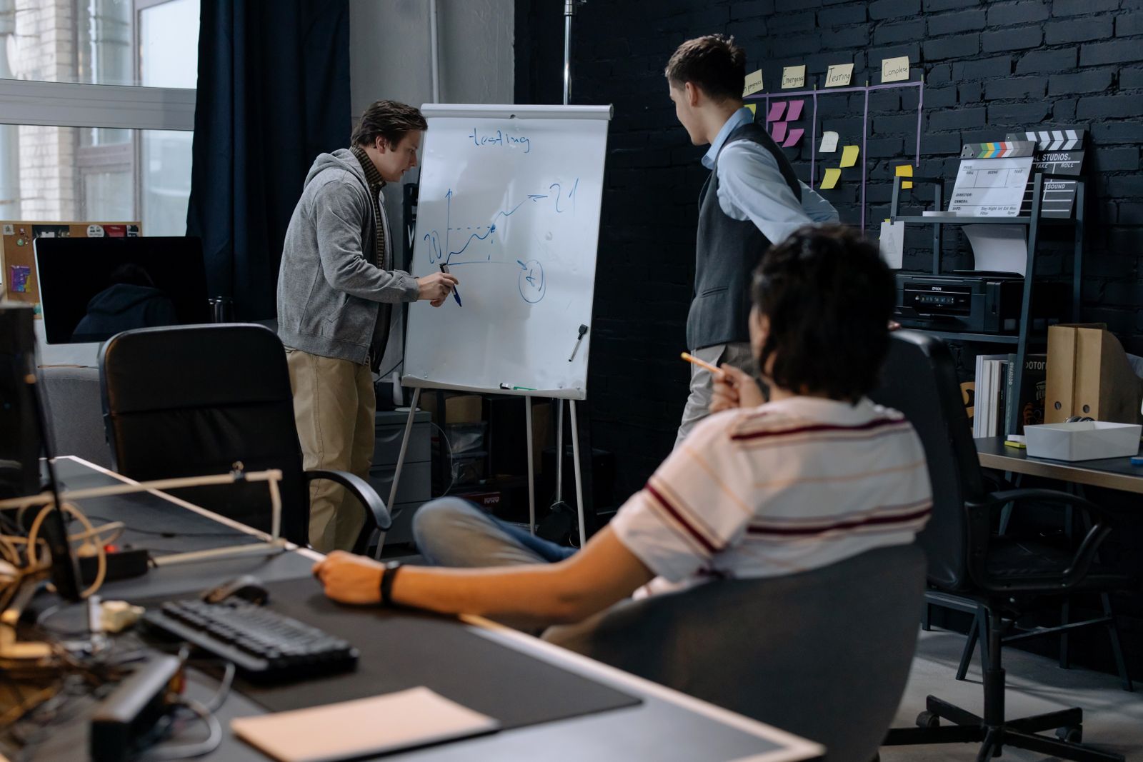Team planning an application around a whiteboard during the design stage