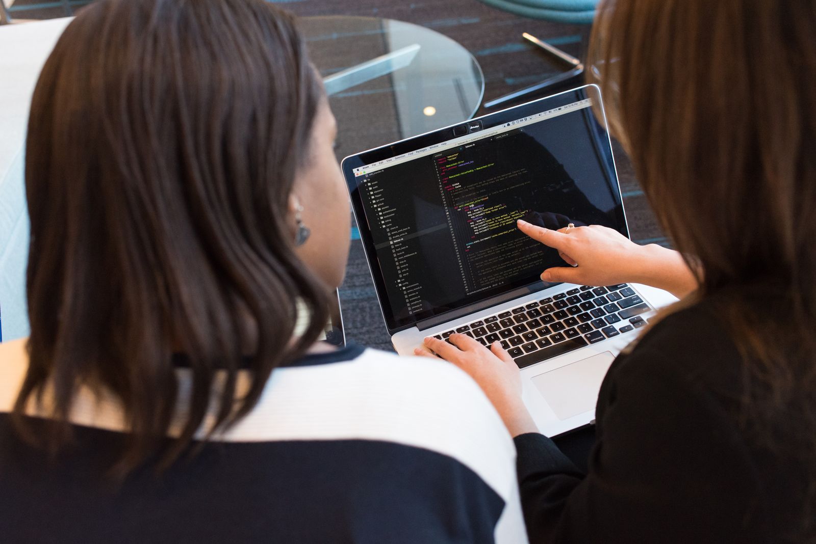 Two team members reviewing application code together during acceptance testing